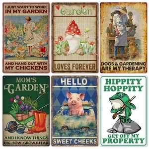 Close-up of vintage metal garden signs with rustic textures and retro animal motifs