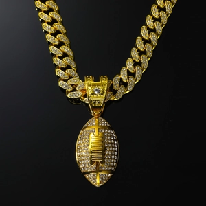 Close-up of golden hip hop rugby pendant with sparkling crystals on a Cuban link chain