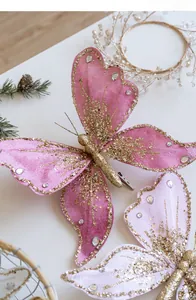 Close-up of glittery fabric butterfly decorations with pink velvet and gold accents
