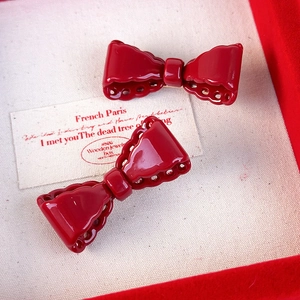 Set of two vintage red resin bow hair clips with hollow edges in a gift box