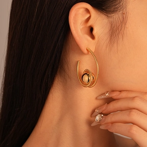 Elegant gold C-shaped hoop earrings with spiral texture and center bead for women