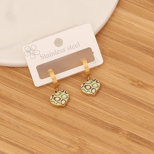Detail of gold heart earrings with colorful enamel ripples on a white display card