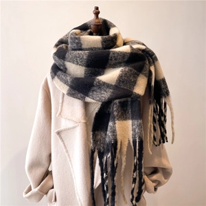 Thick winter cashmere-feel scarf with black and white plaid pattern and tassel fringe