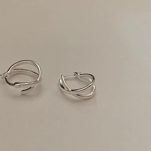 Minimalist 925 sterling silver criss-cross hoop earrings with a sleek metallic finish