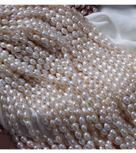 Macro shot of 5-6mm high-luster white freshwater rice pearls for DIY jewelry making