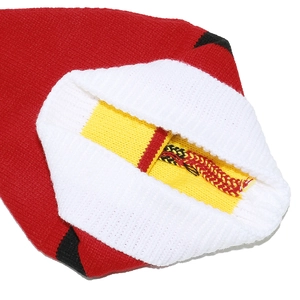 Close-up of the red and white knitted stitch details on this festive Christmas accessory