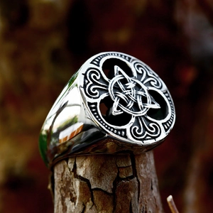 Vintage stainless steel Celtic Triquetra signet ring for men on rustic wood background
