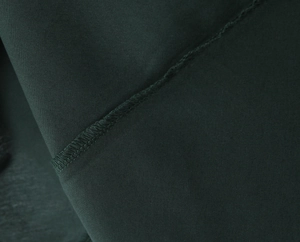 Detailed view of the dark green fabric stitching and seam quality on this sexy maxi dress