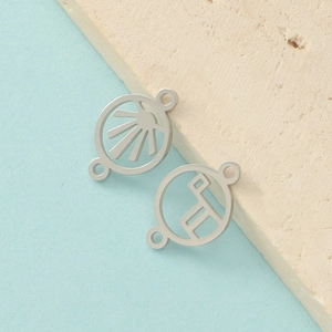 Detail of silver stainless steel sunburst and geometric hollow pendants for DIY jewelry