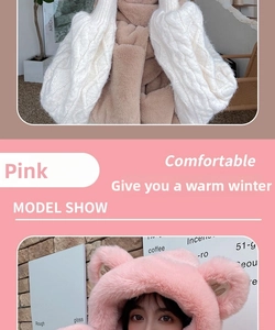 Detail of pink plush bear-ear hat and white cable knit sleeves set for winter warmth