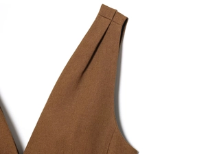 Detailed macro view of the coffee brown twill weave fabric texture and shoulder seam