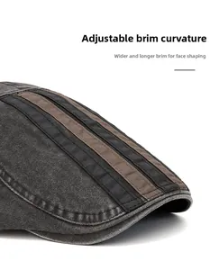 Detail of grey washed cotton flat cap with flexible brim and decorative striped ribbons