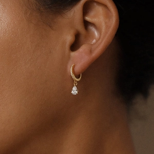 Elegant gold hoop earrings with pavé crystals and sparkling teardrop pendants