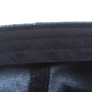 Inside view of washed denim beret featuring reinforced sweatband and fine stitching details