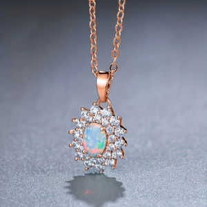 Detail of rose gold sunflower necklace with oval opal stone and sparkling zircon halo