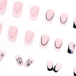 French style press-on nails with black butterflies and white daisy patterns on white base