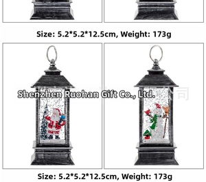 Detail view of retro Christmas lantern with Santa Claus and snowman figurines inside