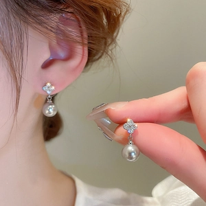 Elegant silver earrings featuring zircon four-leaf clover studs and white pearl drops