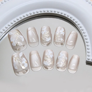 Handmade press-on nails with 3D gold leaves and white flowers in cat-eye pearl finish
