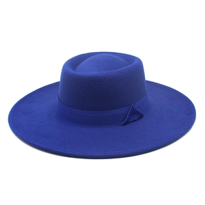 Detail of royal blue wool felt boater hat featuring a matching satin ribbon and flat top