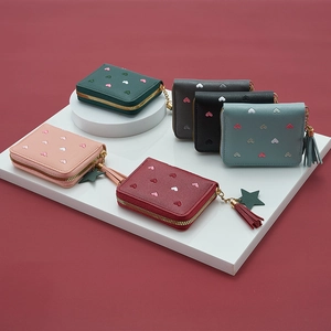 Mini PU leather purses with heart embroidery, gold zippers, and tassel star charms