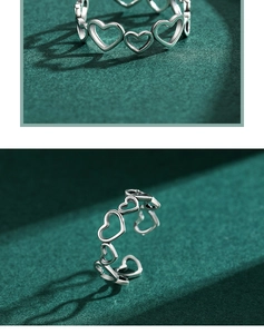 Detailed view of S925 sterling silver ring with hollow heart-shaped chain design