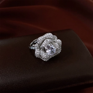 Detailed view of silver flower ring with large oval zircon on dark brown leather