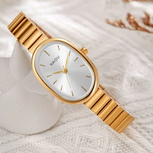 Close-up of golden oval quartz watch with white radial dial and metal linked strap