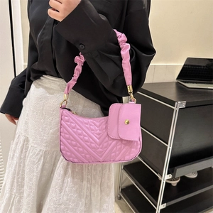 Pink quilted shoulder bag with ruffles cloud handle and mini purse attachment