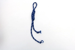 Detail of hand-woven dark blue nylon cord knot with tassel fringe for fashion accessories