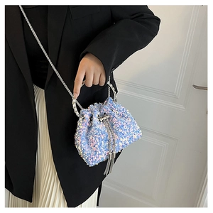 Detailed macro view of the blue sequin bucket bag with silver chain and metal handle