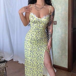 Detail of high side slit on yellow floral dress with delicate white lace neckline