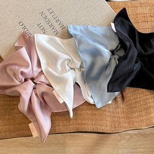 Elegant satin scrunchie set in four pastel colors on a rustic wooden background