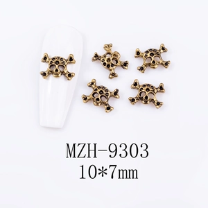 Detailed view of 10x7mm vintage skull nail charms in antique gold finish for Halloween