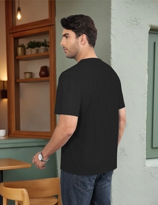 Close-up of the breathable waffle texture fabric on this black short-sleeved men's top