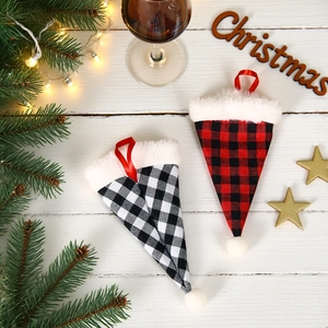 Christmas plaid cutlery holders with plush trim on white wood holiday table setting