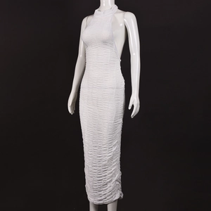 Detail shot of the ruched fabric texture and halter neck on this white backless maxi dress