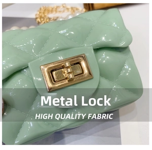 Detail of mint green quilted jelly bag with high-gloss finish and gold metal lock