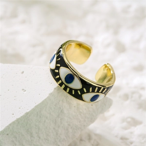 Macro shot of 18K gold plated evil eye adjustable ring with blue enamel detailing