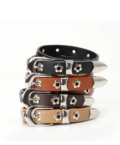Close-up of leather grommet belts in black brown and khaki with floral silver buckles