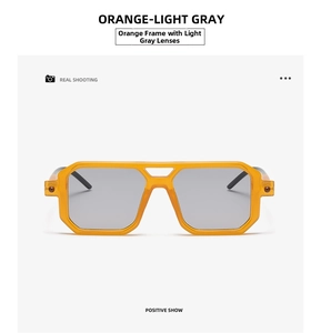 Detail of transparent orange geometric sunglasses with light gray lenses for trendy style