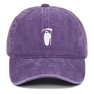 Close-up of Grim Reaper embroidery on vintage purple washed cotton baseball cap texture