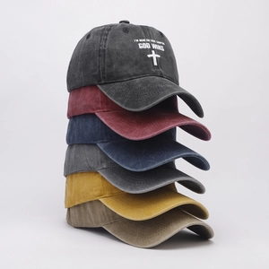 Detail view showing a stack of six vintage washed cotton baseball caps in varied colors