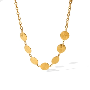 Close-up of golden necklace with seven spiral textured discs on a round link chain