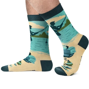 Detail of crew socks featuring a scenic lakeside fishing graphic with blue-green motifs