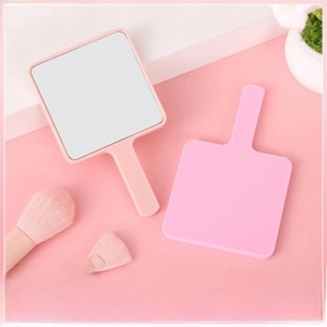 Detailed view of portable square pink handheld makeup mirror with soft ABS handle