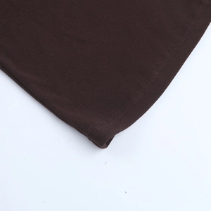 Macro d'un tissu en maille marron foncé montrant les détails de la double couture