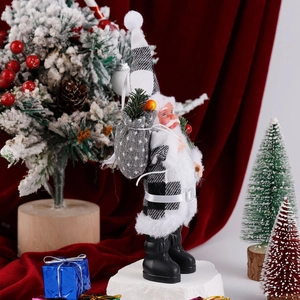 Detailed view of standing Santa plush in black and white plaid coat with burlap gift sack