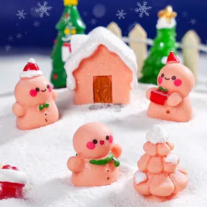 Miniature Christmas gingerbread man figurines with snow-covered house holiday decoration set