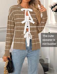 Detail of brown striped cardigan with three white ribbon bow tie closures on the front